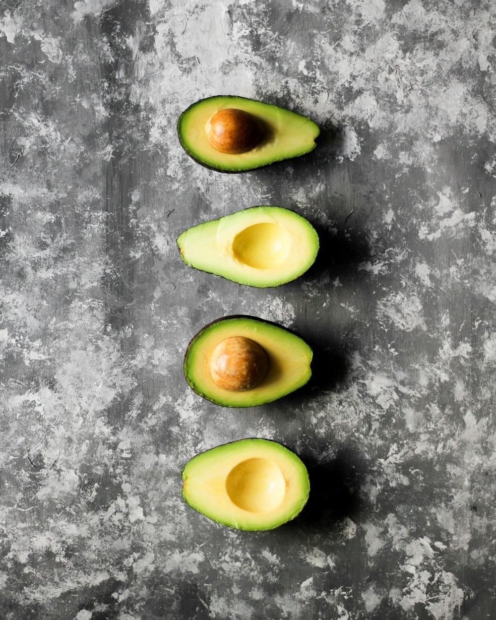 three pieces of avocado sitting on top of a table