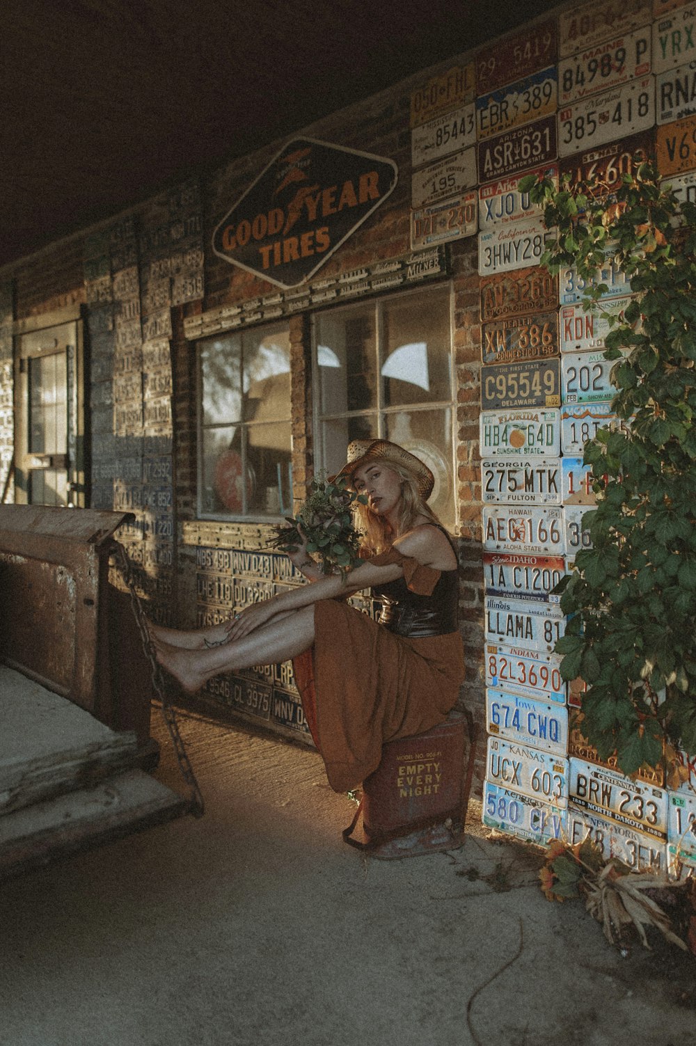 a woman sitting on the porch of a store