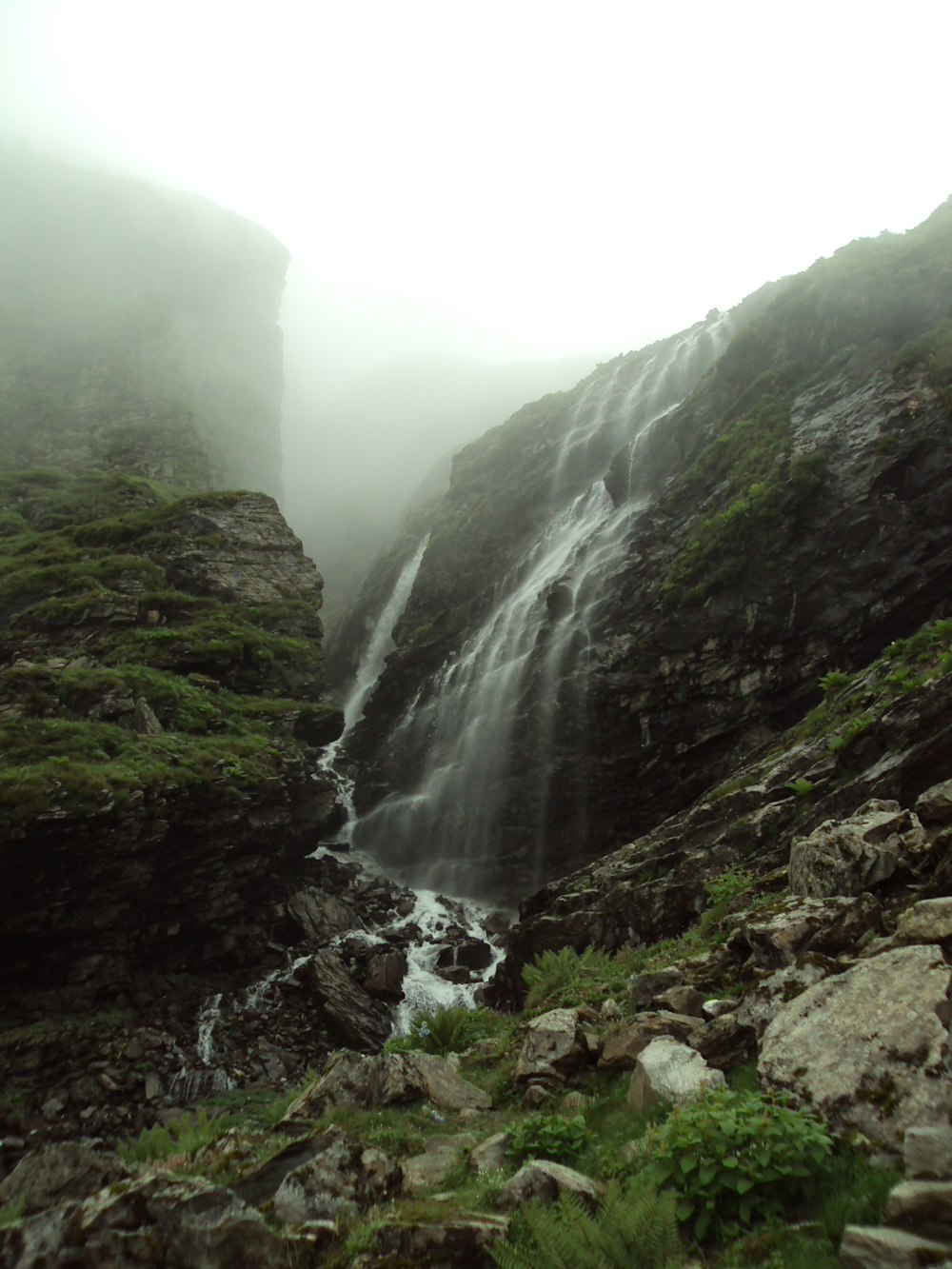 a waterfall in the middle of a rocky area