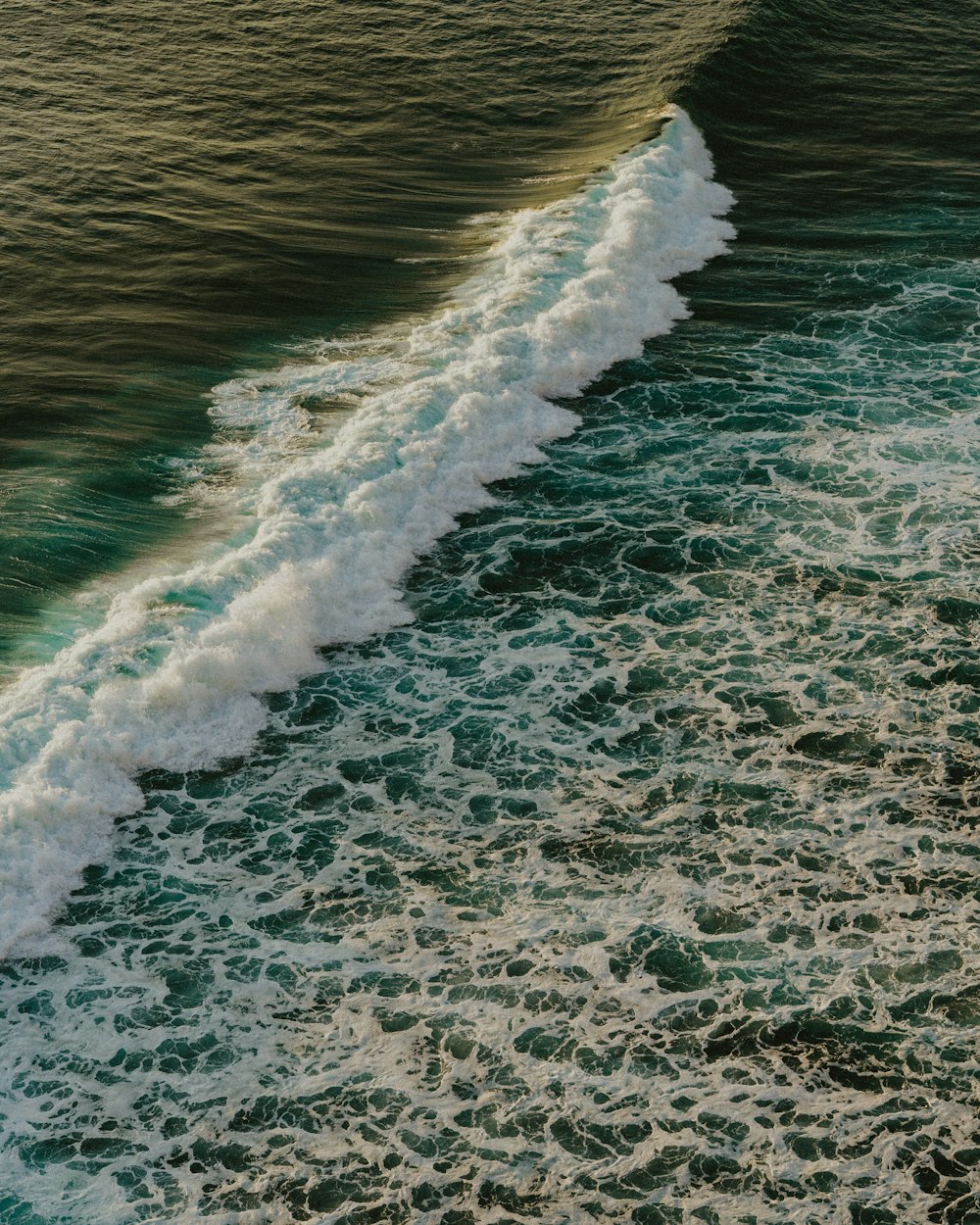 a person riding a surfboard on top of a wave