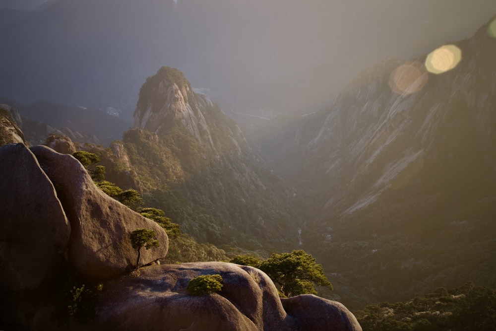 the sun shines on the mountains and rocks