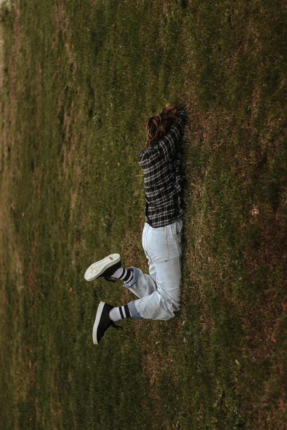 a person laying in the grass with a frisbee