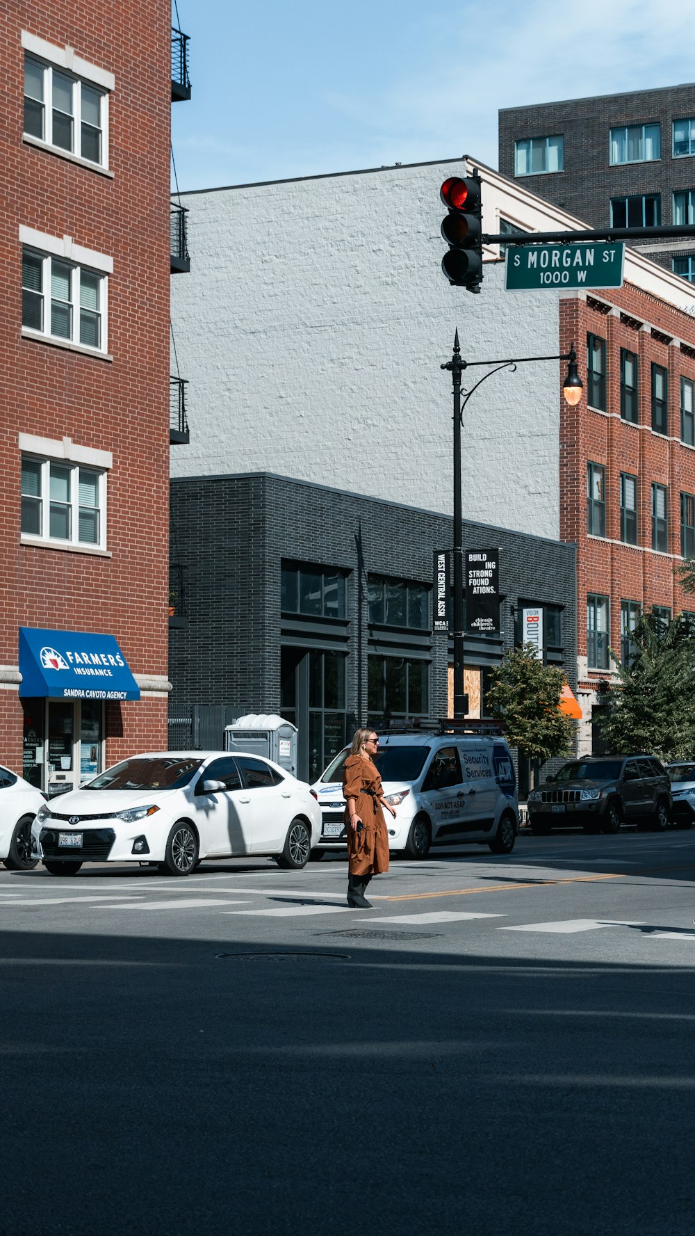 a person crossing a street at a traffic light
