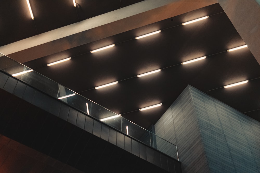 the ceiling of a building with lights above it