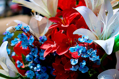 A modern flower board design with bold blue accents and fresh white lilies.