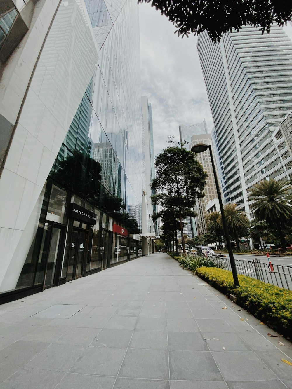 a city street with tall buildings in the background