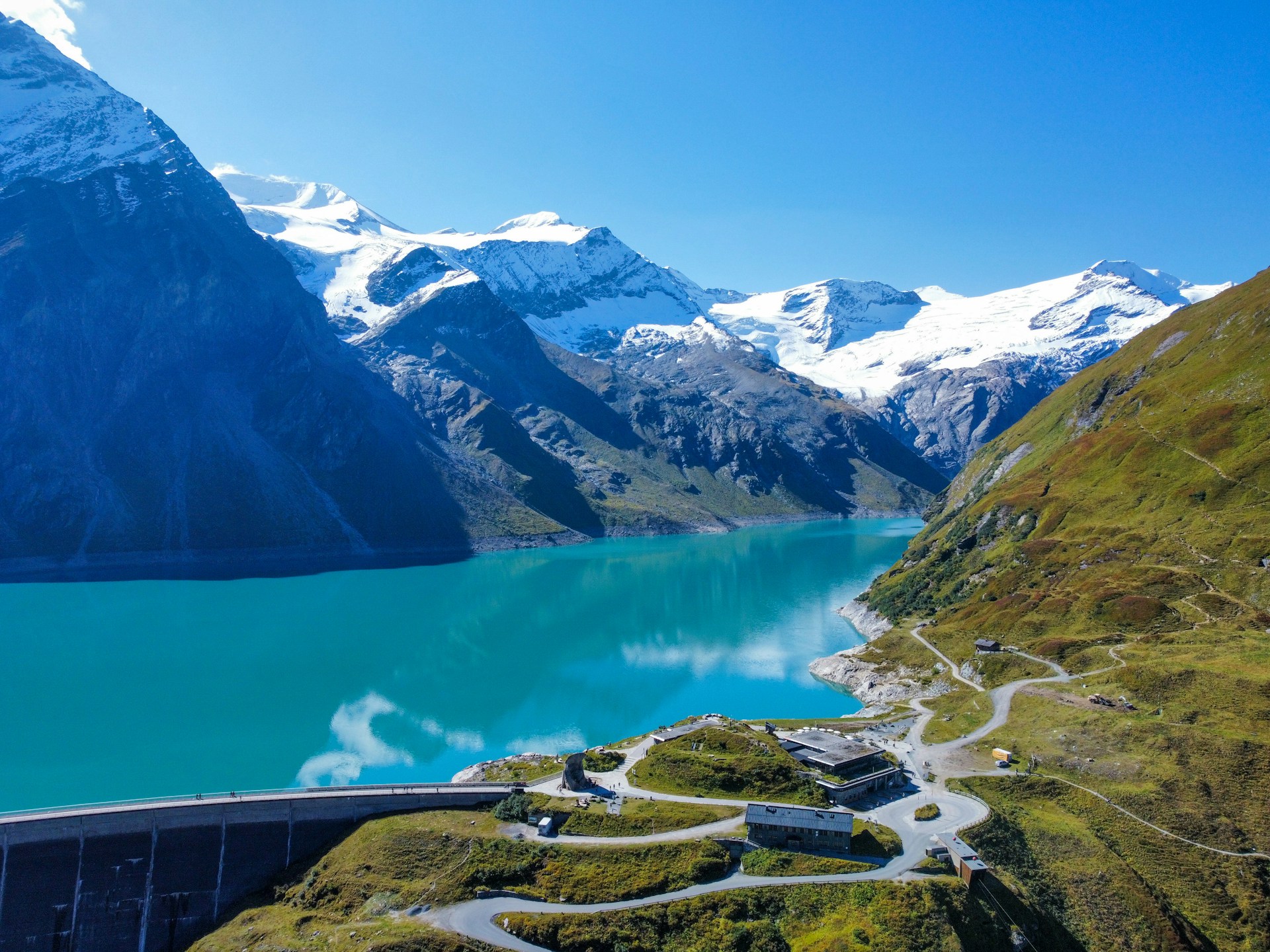 a scenic view of a mountain lake and a road