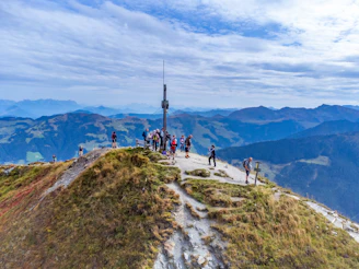 a group of people standing on top of a mountain