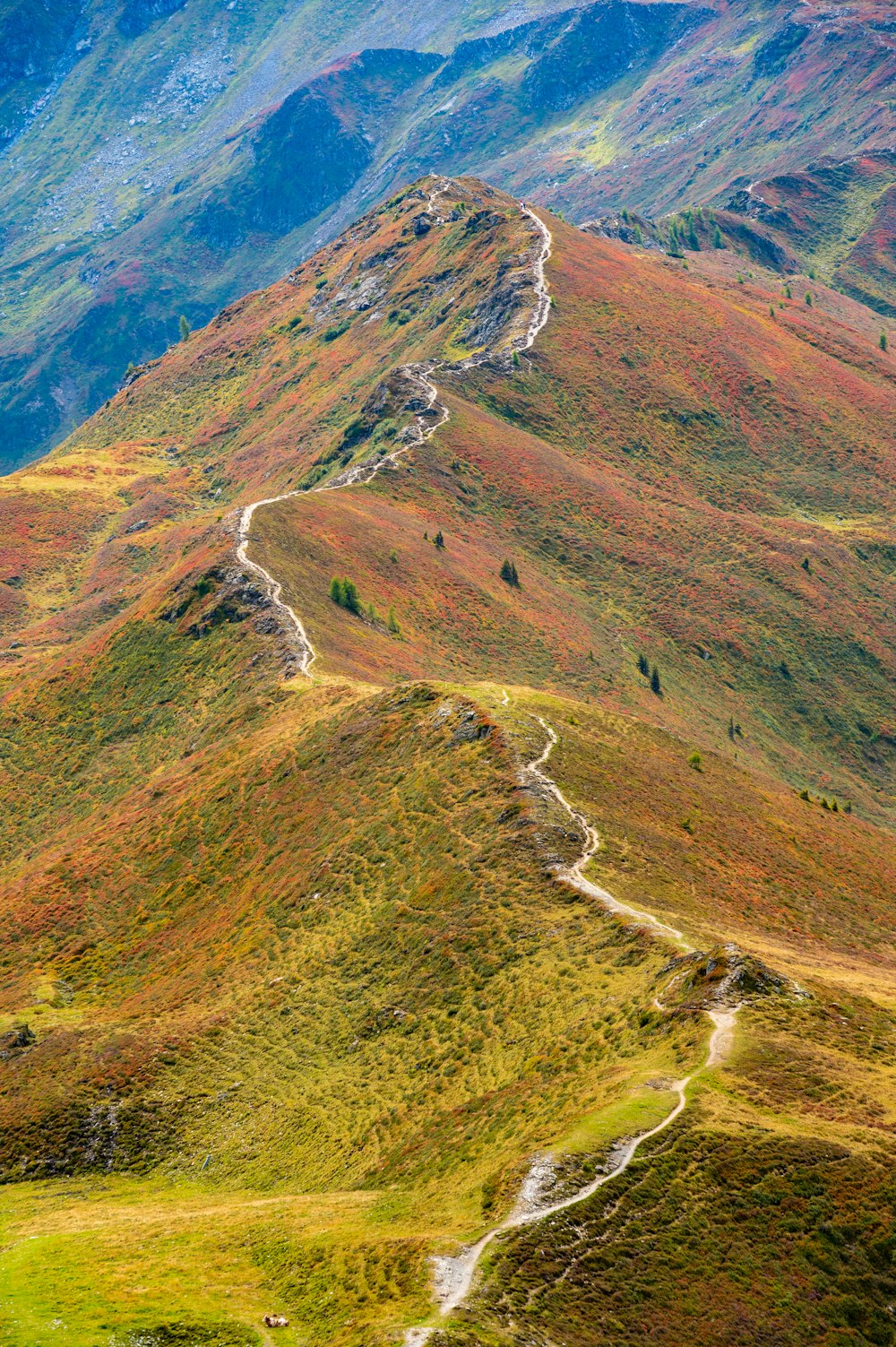 a winding road in the middle of a mountain range