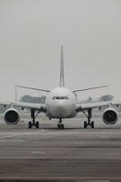 a large jetliner sitting on top of an airport runway