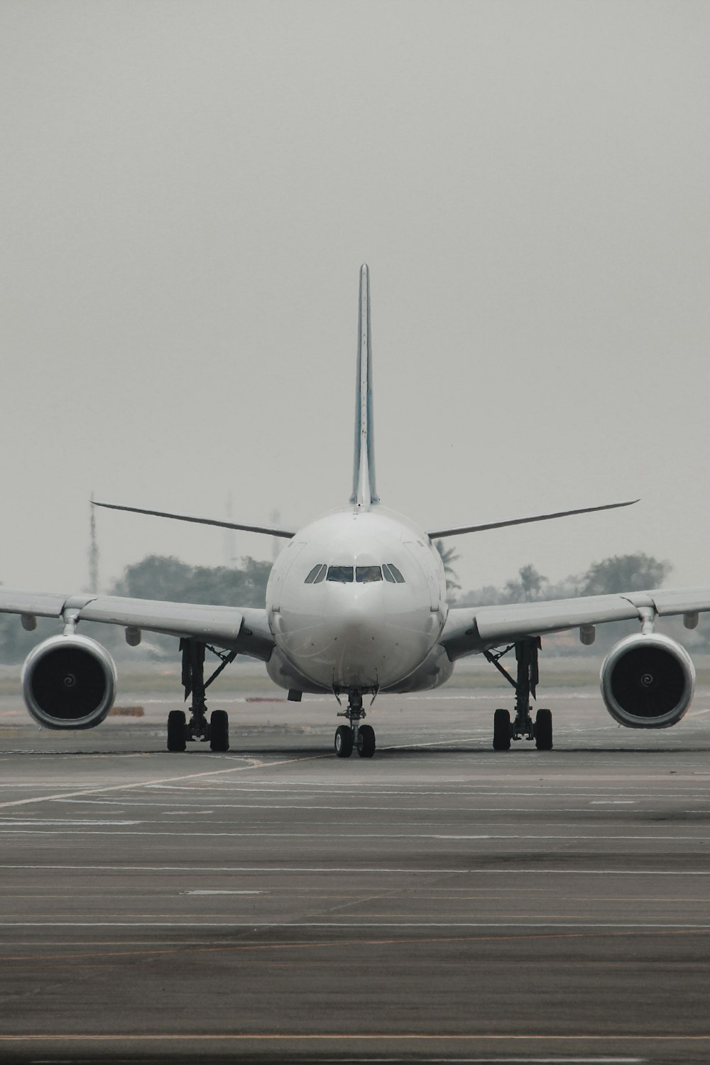 a large jetliner sitting on top of an airport runway