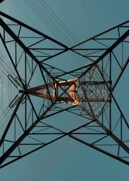 an overhead view of a power line with a blue sky in the background