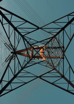 an overhead view of a power line with a blue sky in the background