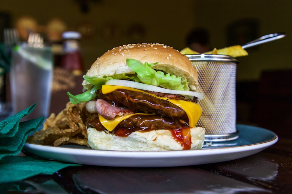 a plate with a sandwich and a drink on a table