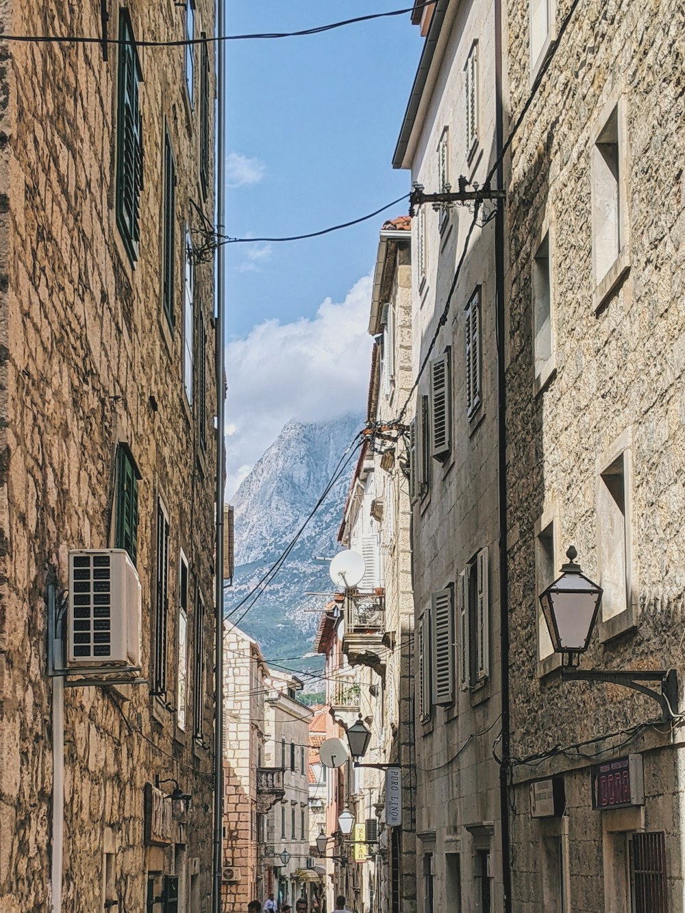 a cobblestone street with a mountain in the background