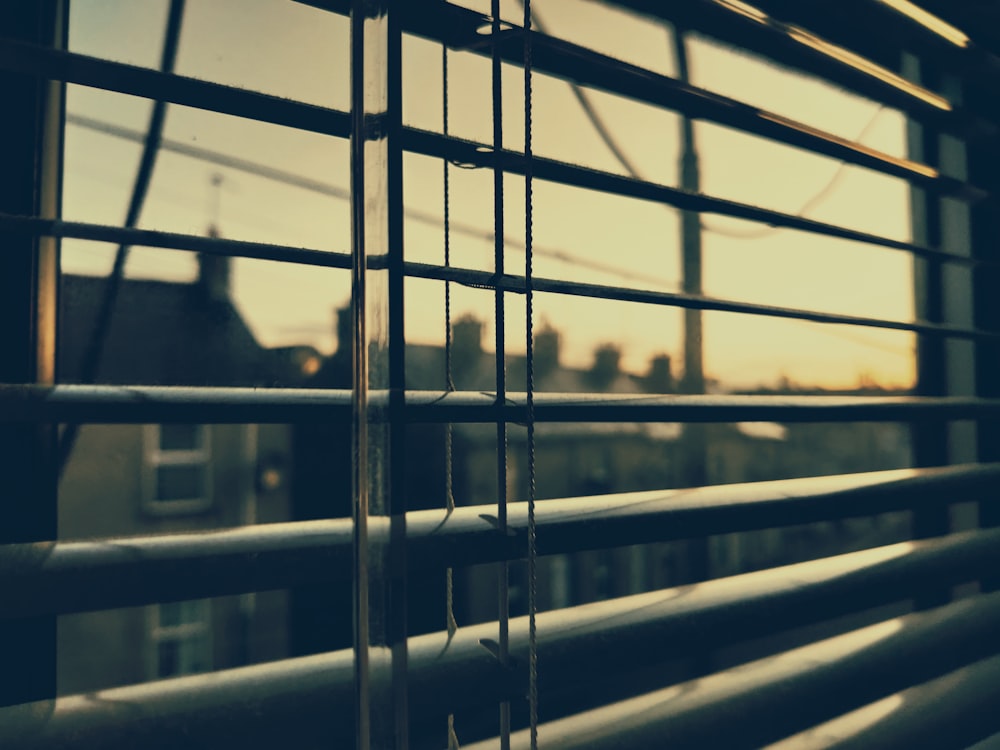 a close up of a window with a blind in front of it