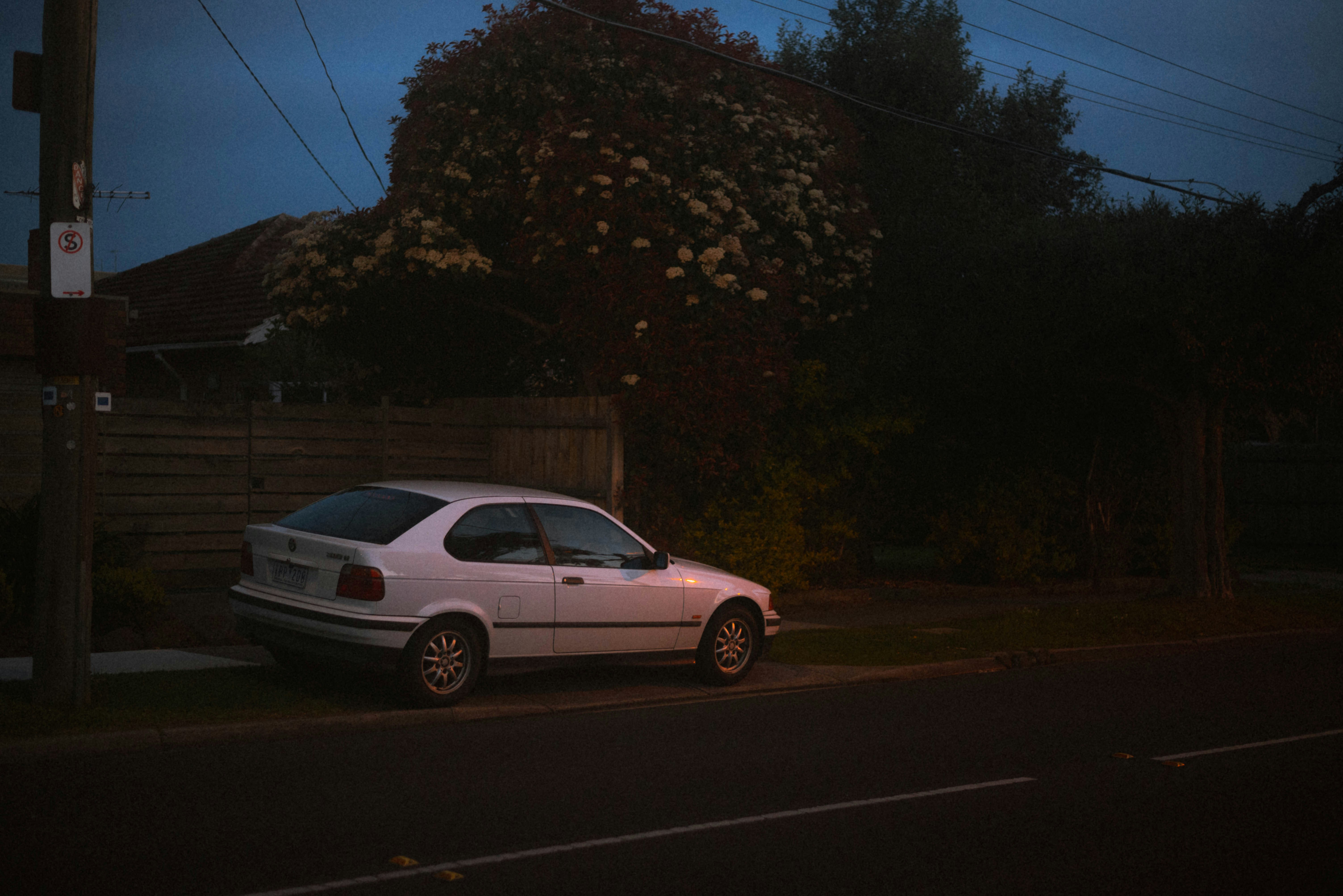 A white car parked on the side of the road photo – Free Car Image on ...