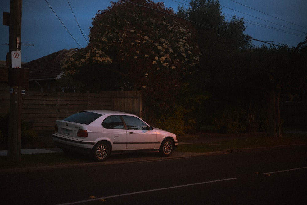 a white car parked on the side of the road