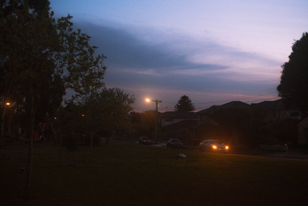 a couple of cars that are parked in the grass