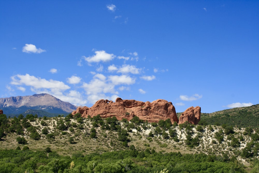 a mountain range with trees and mountains in the background