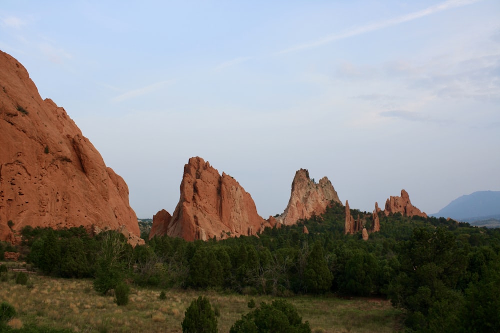 a group of large rocks in the middle of a field