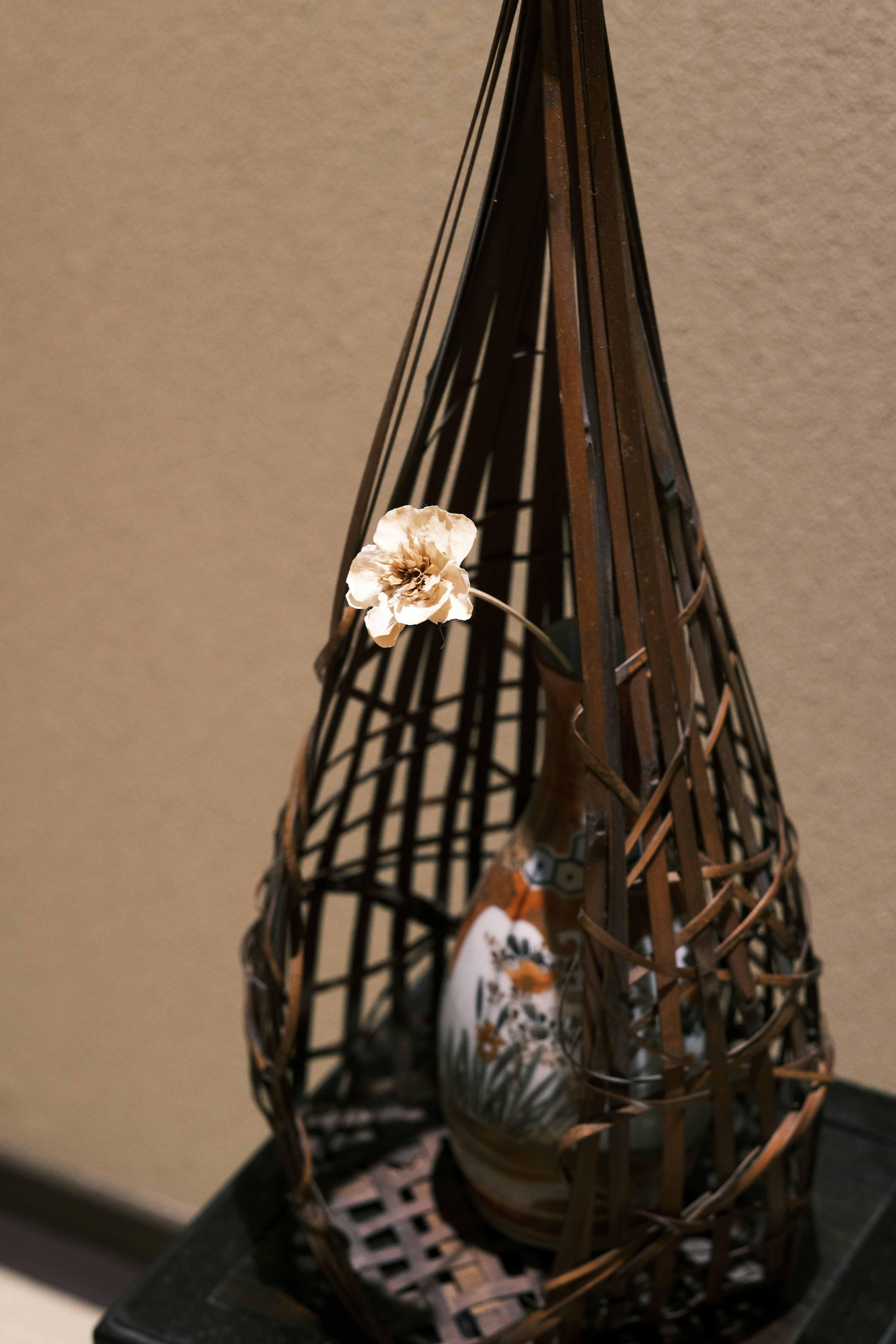 a vase with a flower in it sitting on a table