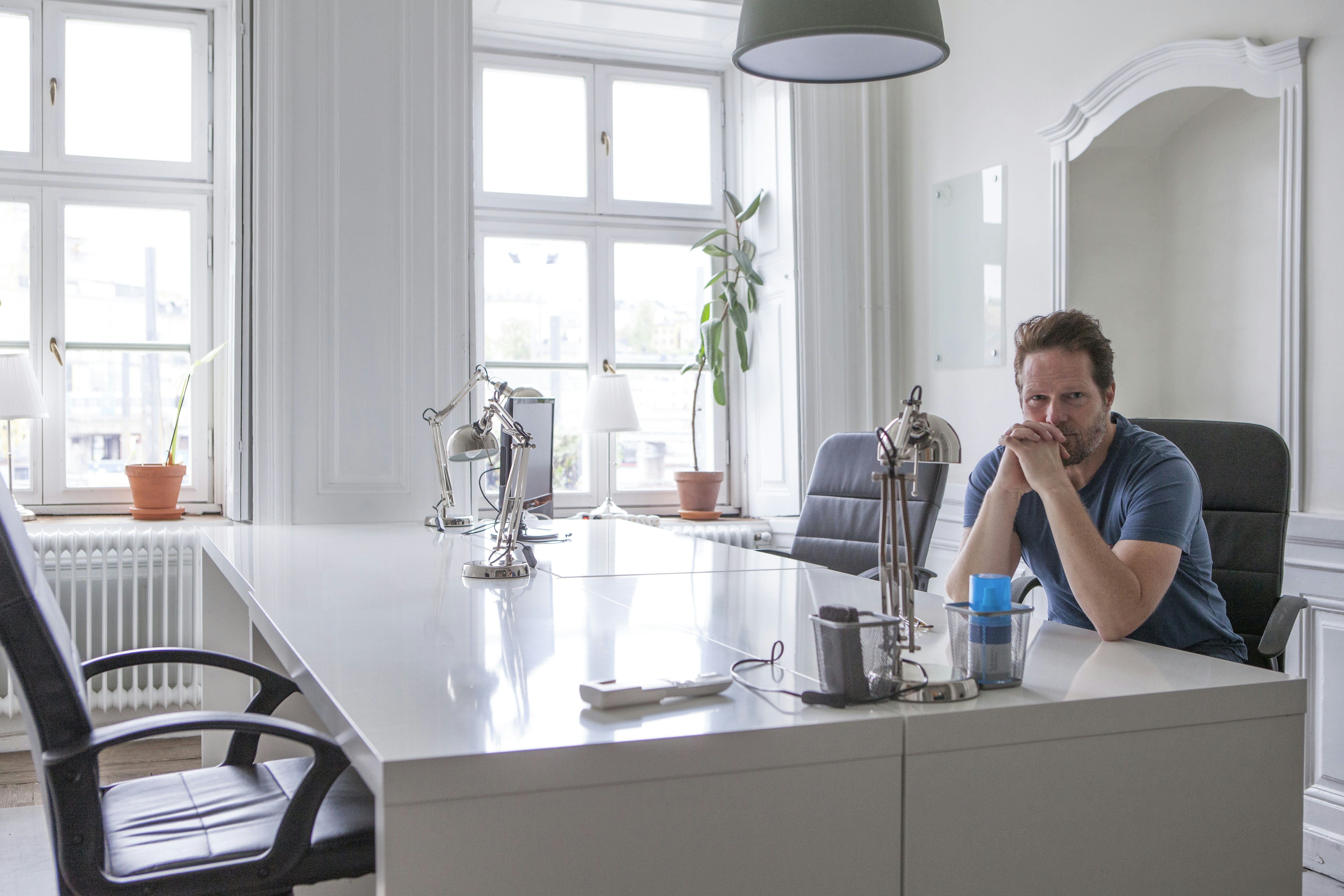 a man sitting at a table in a kitchen