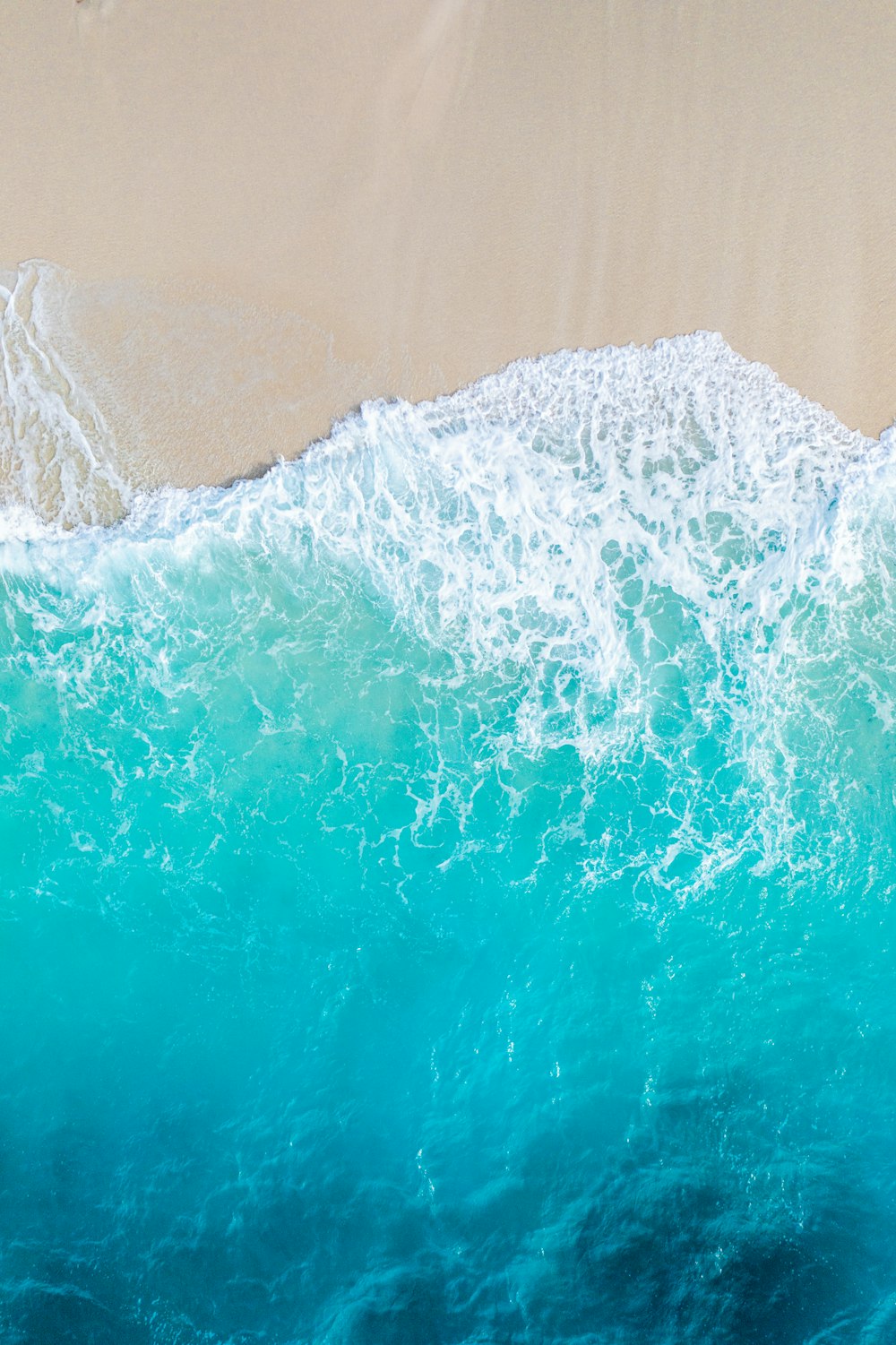 a person riding a surfboard on top of a wave