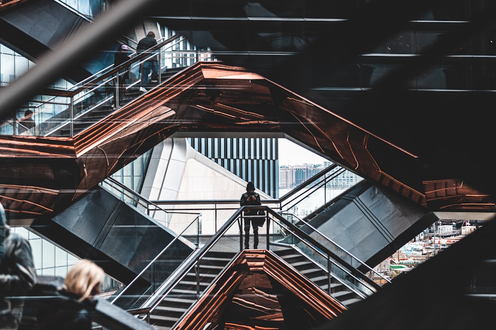 a man standing on a stair case in a building