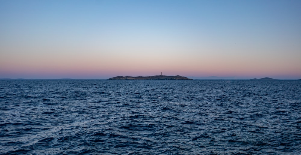 a body of water with a small island in the distance