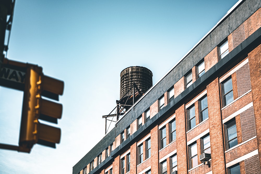 a tall brick building with a water tower on top