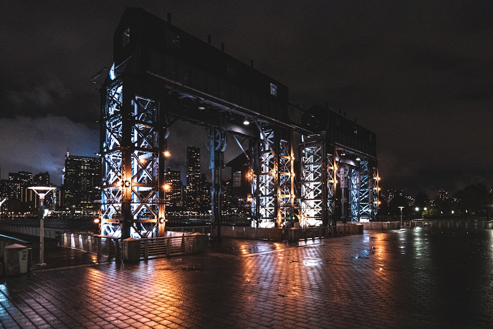 a train crossing over a bridge at night