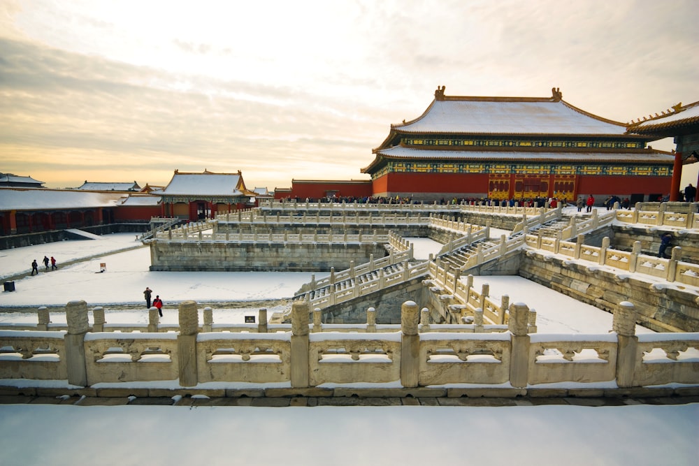 a snow covered area with a building in the background