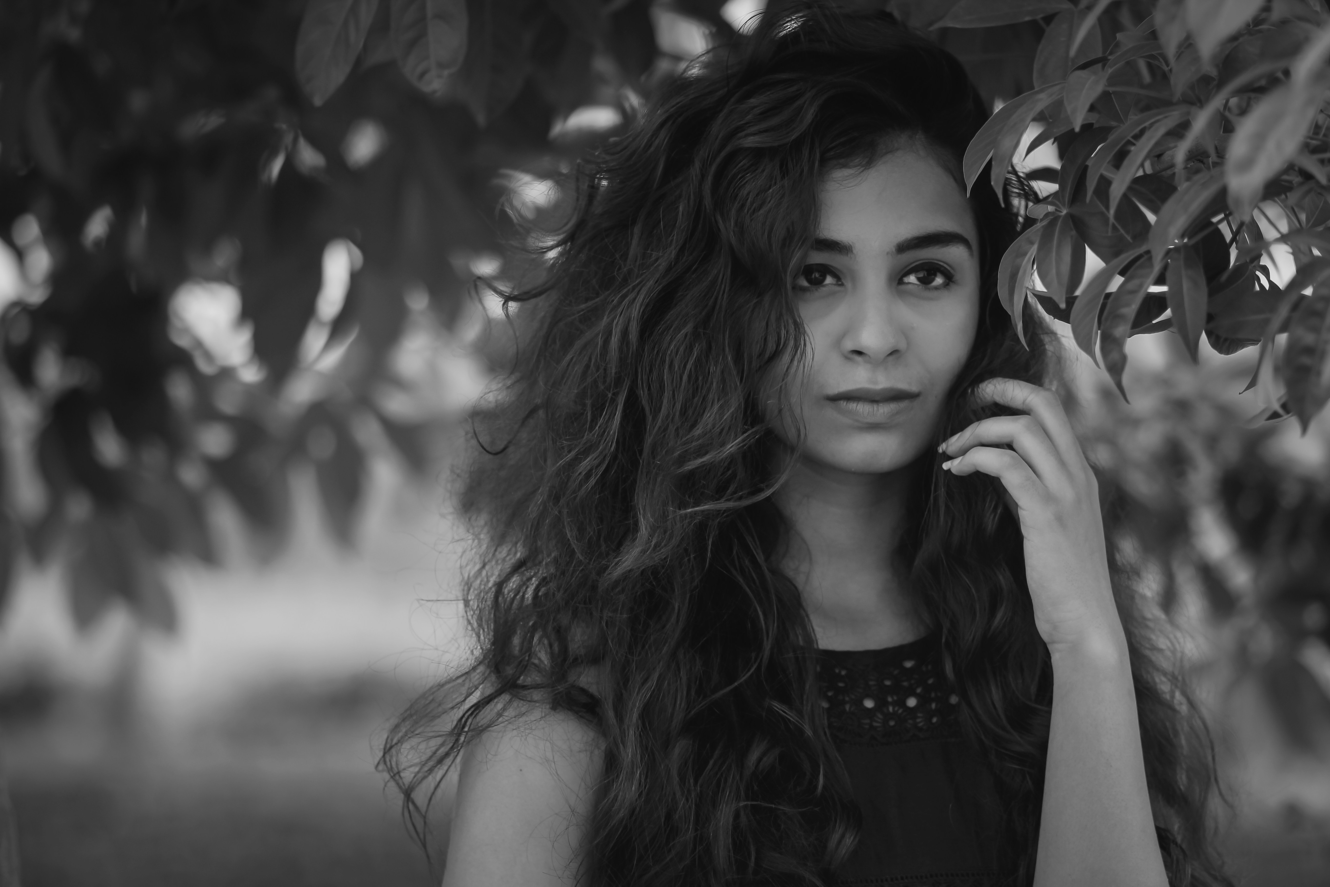 a black and white photo of a woman talking on a cell phone