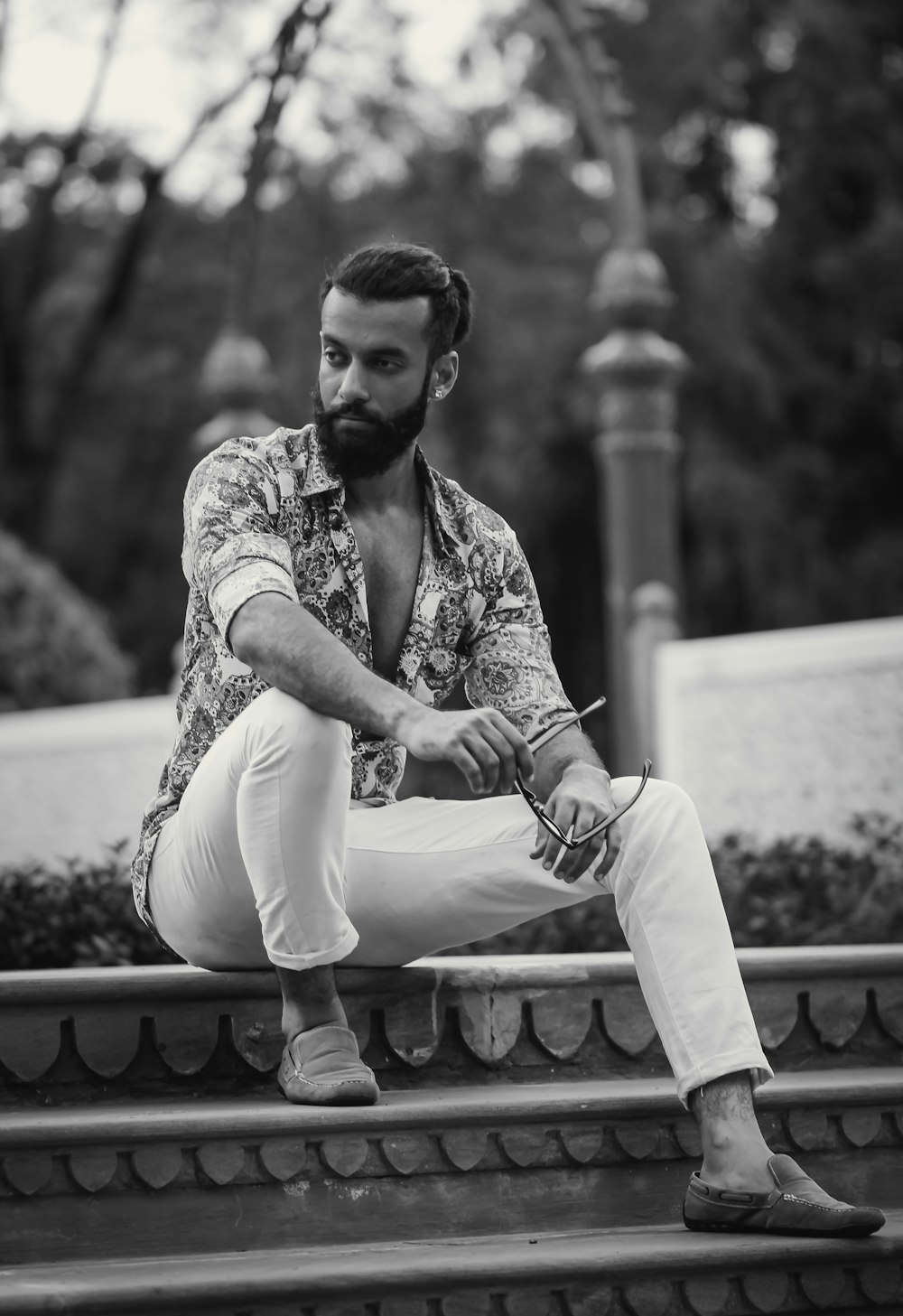 a man with a beard sitting on some steps