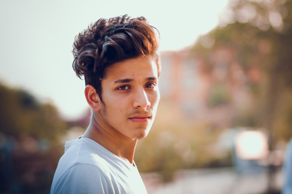 a close up of a person wearing a white shirt