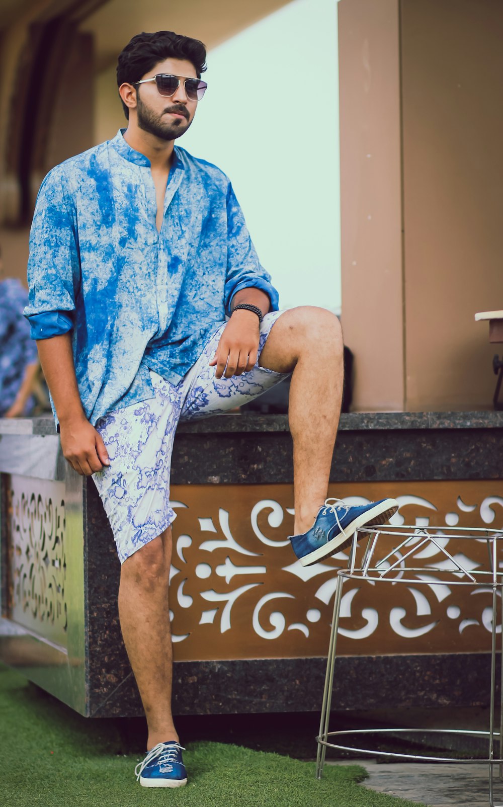 a man sitting on top of a wooden bench