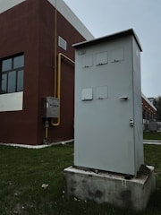 a white box sitting on top of a cement block