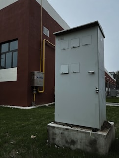 a white box sitting on top of a cement block
