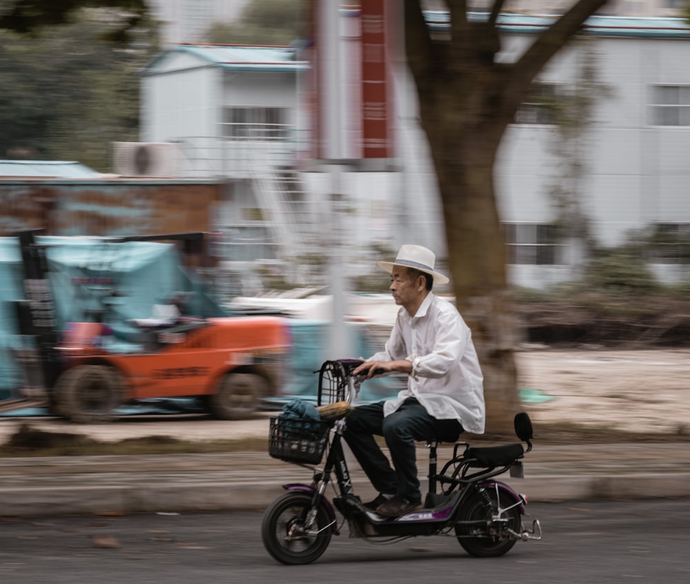 a man riding a scooter down a street