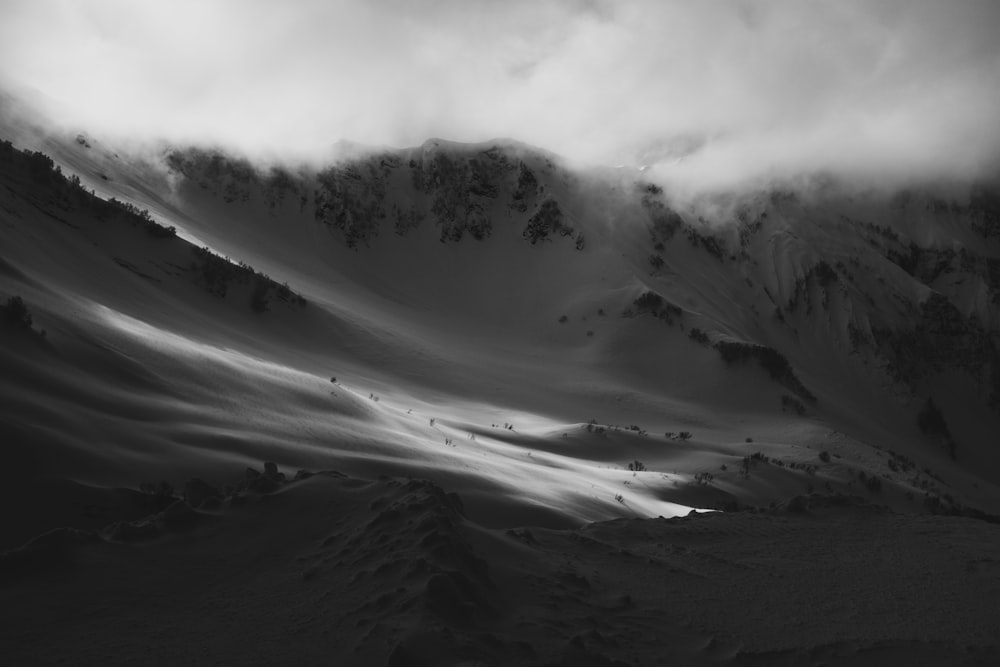 a black and white photo of a snow covered mountain