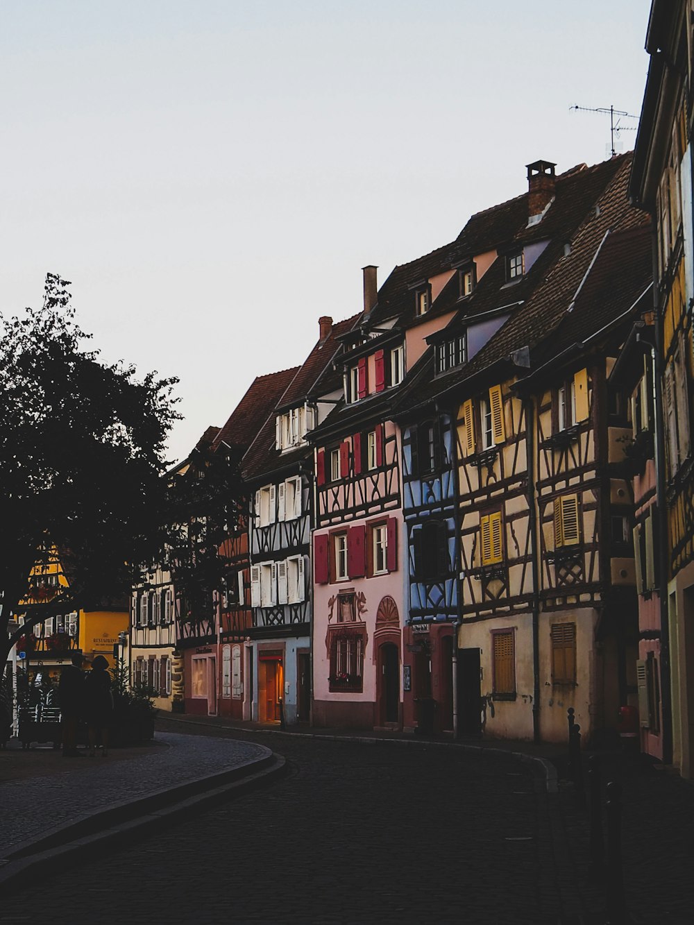 a cobblestone street lined with tall buildings