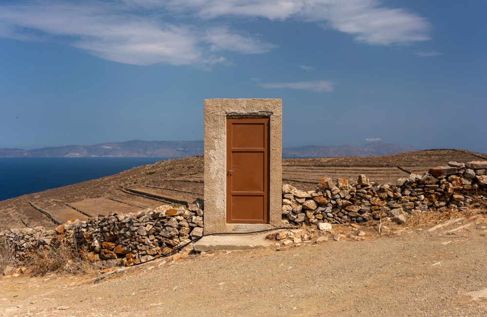 a door on the side of a stone wall