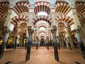 the inside of a building with columns and arches