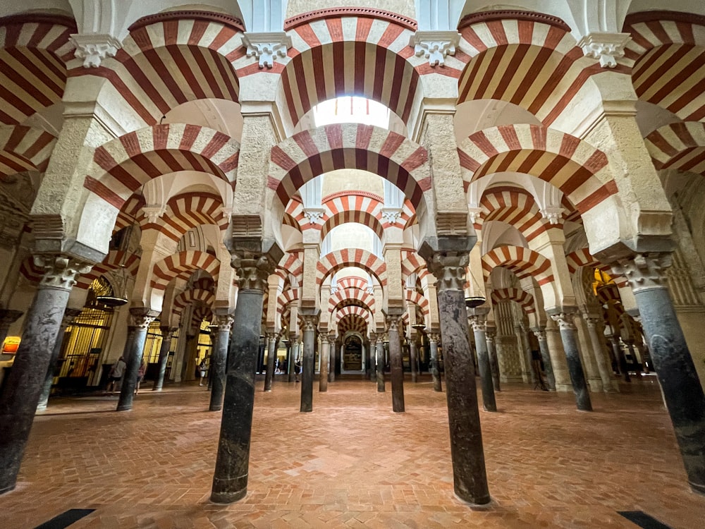 the inside of a building with columns and arches