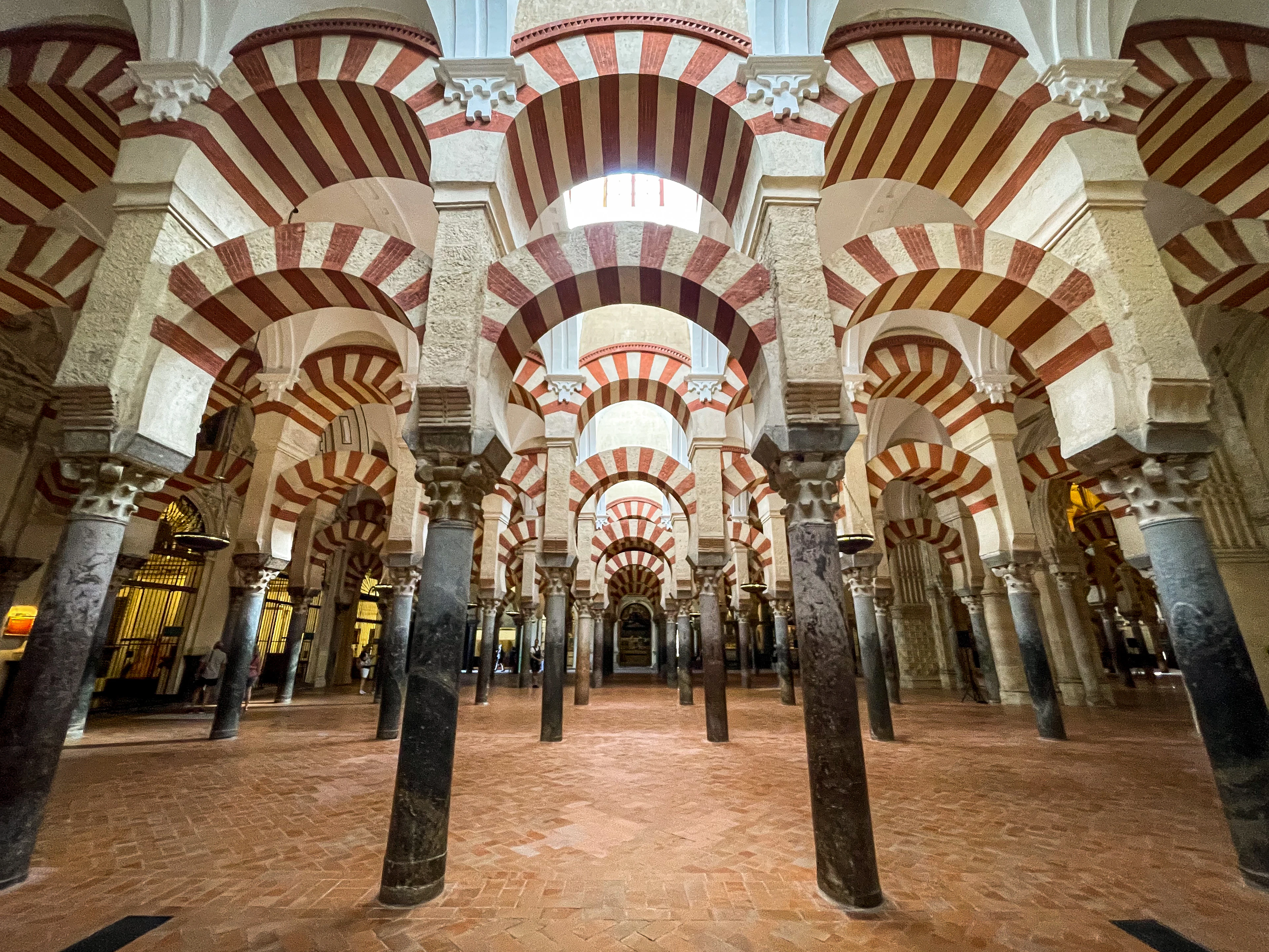 Rows of red-and-white arches and columns inside the Mosque-Cathedral of Córdoba