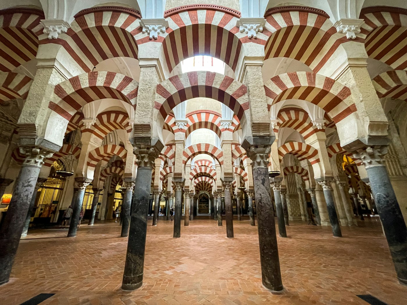 Rows of red and white striped arches inside the Mezquita in Cordoba