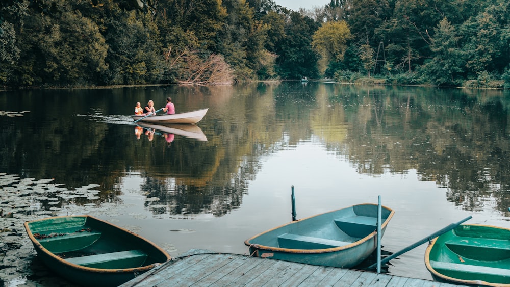 a couple of boats floating on top of a lake