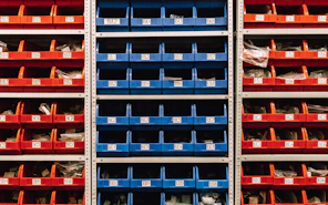 a large stack of red, blue, and orange bins