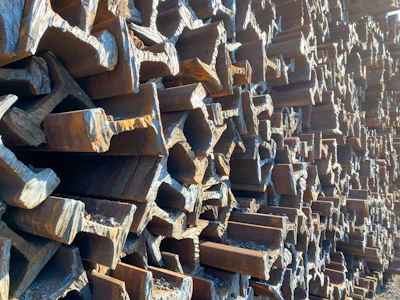 Constructed steel beams stacked neatly in a warehouse illuminating strength and order.